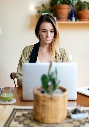 exceed-nutrition-female-coach-working-on-laptop