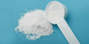 A scope of powder half poured with a blue background