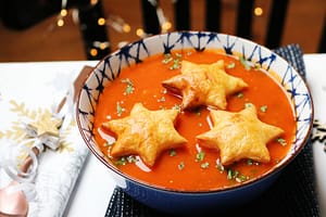 christmas soup recipe with pastry stars with fairy lights and spoon
